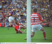 10 August 2003; Rory McCarthy of Wexford, shoots the sliothar past corner of Diarmuid O'Sullivan and goalkeeper Donal Og Cusack of Cork to score his sides third goal and level the game during the Guinness All-Ireland Senior Hurling Championship Semi-Final match between Cork and Wexford at Croke Park in Dublin. Photo by Ray McManus/Sportsfile