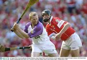 10 August 2003; Wexford goalkeeper Damien Fitzhenry, using a Paddy Power sponsored hurley, in action against Setanta O'hAilpin of Cork during the Guinness All-Ireland Senior Hurling Championship Semi-Final match between Cork and Wexford at Croke Park in Dublin. Photo by Damien Eagers/Sportsfile
