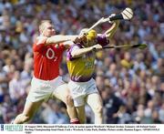 10 August 2003; Diarmuid O'Sullivan of Cork, in action against Michael Jordan of Wexford during the Guinness All-Ireland Senior Hurling Championship Semi-Final match between Cork and Wexford at Croke Park in Dublin.