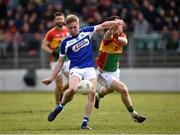 25 March 2018; Alan Farrell of Laois kicks a point under pressure from Darragh Foley of Carlow during the Allianz Football League Division 4 Round 7 match between Carlow and Laois at Netwatch Cullen Park in Carlow. Photo by Seb Daly/Sportsfile