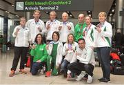 25 March 2018; Irish Masters team members, from left, Team Manager Anne Gormley, Ian Egan, Robert Maher, Joe Gough, Patrick Malone, Maggie O'Connor, Bríd Lawlor, front row, Aishling Smith, Michelle Kenny, Jackie Carthy and Team captain Ronan Kearns, on their arrival at Dublin Airport after a successful week competing at the European Masters Indoor Track & Field Championships in Madrid, at Dublin Airport in Dublin. Photo by Tomás Greally/Sportsfile