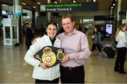 30 April 2018; Katie Taylor, who won both the WBA and IBF World Lightweight World Champion belts on Saturday night,  with the Unified WBA belt and manager Brian Peters on her arrival home at Dublin Airport, Dublin. Photo by David Fitzgerald/Sportsfile