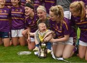 7 May 2018; Caragh Masterson, daughter of Wexford manager Anthony Masterson, sits in the cup during the celebrations after the Lidl Ladies Football National League Division 3 Final match between Meath and Wexford at St Brendan's Park, in Birr, Offaly.  Photo by Piaras Ó Mídheach/Sportsfile