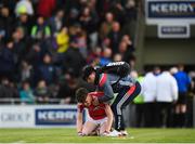 8 May 2018; David Buckley of Cork is consoled by a supporter following the Electric Ireland Munster GAA Football Minor Championship semi-final match between Kerry and Cork at Austin Stack Park, in Tralee, Kerry.  Photo by Eóin Noonan/Sportsfile