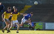 12 May 2018; Ross Munnelly of Laois scores a point past Wexford defenders Alan Nolan and Naomhan Rossiter during the Leinster GAA Football Senior Championship Preliminary Round match between Wexford and Laois at Innovate Wexford Park in Wexford. Photo by Matt Browne/Sportsfile