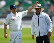 13 May 2018; Tim Murtagh of Ireland retrieves his sunglasses from the head of umpire Richard Illingwroth during day three of the International Cricket Test match between Ireland and Pakistan at Malahide, in Co. Dublin. Photo by Seb Daly/Sportsfile