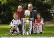12 August 2003; Sky Sports soccer analyst Andy Gray with Liverpool fan Kenneth Kelly, aged 10, Manchester United fan Thomas O'Keeffe, age 9, and Arsenal fan Joseph Barry Wallace, age 9, all from Dublin, and the FA Premiership trophy at a photocall to highlight Sky Sports live coverage of the Barclaycard Premiership which kicks off this Saturday with the game between Portsmouth and Aston Villa. Soccer. Picture credit; Brendan Moran / SPORTSFILE *EDI*