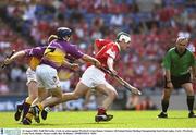16 August 2003; Niall McCarthy, Cork, in action against Wexford's Liam Dunne. Guinness All-Ireland Senior Hurling Championship Semi-Final replay, Cork v Wexford, Croke Park, Dublin. Picture credit; Ray McManus / SPORTSFILE *EDI*
