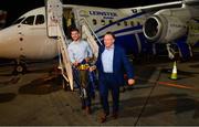 12 May 2018; Leinster senior rehabilitation coach Diarmaid Brennan, left, and Leinster team doctor Prof John Ryan carry the Champions Cup trophy off the plane in Dublin airport following their victory over Racing 92 in Bilbao, Spain. Photo by Ramsey Cardy/Sportsfile