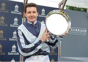 27 May 2018; Jockey Colm O'Donoghue holds up the winning trophy after he rode Alpha Centauri to win the Tattersalls Irish 1,000 Guineas during the Curragh Races Irish 1000 Guineas Day at the Curragh in Kildare. Photo by Barry Cregg/Sportsfile