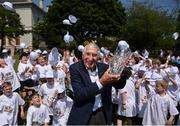 31 May 2018; Ronnie Delany was guest of honour at his alma mater, CUS Sports Day at College Park, Trinity College. CUS Junior School on Leeson Street is celebrating 150 years of the school. Teachers and children also joined to celebrate the 62nd anniversary of when Ronnie Delany became the first Irish man to break 4 minutes for the mile in Compton, USA, running 3:59.0 on June 1st, 1956, the same year he won gold over 1500m at the Olympic Games in Melbourne. Ronnie Delany is pictured lifting his presentation trophy in attendance with participants during The Ronnie Delany &quot;Smile Run&quot;, at College Park, Trinity College, Dublin. Photo by David Fitzgerald/Sportsfile