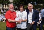 31 May 2018; Ronnie Delany was guest of honour at his alma mater, CUS Sports Day at College Park, Trinity College. CUS Junior School on Leeson Street is celebrating 150 years of the school. Teachers and children also joined to celebrate the 62nd anniversary of when Ronnie Delany became the first Irish man to break 4 minutes for the mile in Compton, USA, running 3:59.0 on June 1st, 1956, the same year he won gold over 1500m at the Olympic Games in Melbourne. Pictured is Cyril Smyth, left, Trinity College, Catherine Sheelan, Principal of CUS Junior School, centre, making a presentation to Ronnie Delany during The Ronnie Delany &quot;Smile Run&quot;, at College Park, Trinity College, Dublin. Photo by David Fitzgerald/Sportsfile