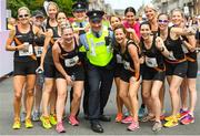 3 June 2018; Inspector Martin Mooney and Sergeant Lisa McCarthy with participants from Clonliffe Harriers, Dublin, during the 2018 Vhi Women’s Mini Marathon. 30,000 women from all over the country took to the streets of Dublin to run, walk and jog the 10km route, raising much needed funds for hundreds of charities around the country. www.vhiwomensminimarathon.ie. Photo by Ramsey Cardy/Sportsfile