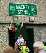 9 June 2018; Bobby Linnane, aged 8, from Swinford, Co. Mayo, assists steward Tom Doran with removing concession signs from outside the ground prior to the GAA Football All-Ireland Senior Championship Round 1 match between Limerick and Mayo at the Gaelic Grounds in Limerick. Photo by Diarmuid Greene/Sportsfile