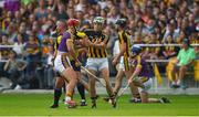 9 June 2018; Referee James McGrath watches play as he stands between Lee Chin of Wexford and Martin Keoghan of Kilkenny, before issuing them both with yellow cards, during the Leinster GAA Hurling Senior Championship Round 5 match between Kilkenny and Wexford at Nowlan Park in Kilkenny. Photo by Ray McManus/Sportsfile