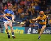 10 June 2018; Sean Hayes of Tipperary in action against Mike Gough of Clare  during the Electric Ireland Munster GAA Hurling Minor Championship match between Tipperary and Clare at Semple Stadium in Thurles, Tipperary. Photo by Ray McManus/Sportsfile