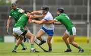 10 June 2018; Kevin Moran of Waterford is tackled by Diarmaid Byrnes, left, and Darragh O'Donovan of Limerick during the Munster GAA Hurling Senior Championship Round 4 match between Limerick and Waterford at the Gaelic Grounds in Limerick. Photo by Ramsey Cardy/Sportsfile