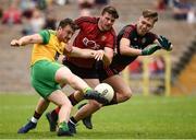 10 June 2018; Leo McLoone of Donegal scores his side's first goal despite the tackle of Anthony Doherty, left, and Marc Reid of Down during the Ulster GAA Football Senior Championship Semi-Final match between Donegal and Down at St Tiernach's Park in Clones, Monaghan. Photo by Oliver McVeigh/Sportsfile