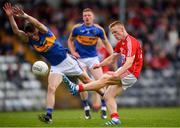 16 June 2018; Damien Gore of Cork scores a point despite the efforts of Gavin Whelan of Tipperary during the EirGrid Munster GAA Football U20 Championship quarter-final match between Cork and Tipperary at Páirc UÍ Rinn, Cork. Photo by Eóin Noonan/Sportsfile