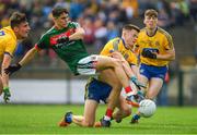 17 June 2018; Tommy Conroy of Mayo is tackled by Aidan Dowd of Roscommon, supported by team-mate Luke Mollahan, left, and Damien Duff during the EirGrid Connacht GAA Football U20 Championship Final match between Mayo and Roscommon at Dr Hyde Park in Roscommon. Photo by Piaras Ó Mídheach/Sportsfile