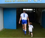 17 June 2018; Michael Walsh of Waterford makes his way to the dressing room with his son Tadhg, age 2, after the Munster GAA Hurling Senior Championship Round 5 match between Waterford and Cork at Semple Stadium in Thurles, Tipperary. Photo by Matt Browne/Sportsfile