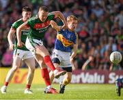 23 June 2018; Andy Moran of Mayo fires a shot at goal despite the attention of  Brian Fox of Tipperary during the GAA Football All-Ireland Senior Championship Round 2 match between Tipperary and Mayo at Semple Stadium in Thurles, Tipperary. Photo by Ray McManus/Sportsfile