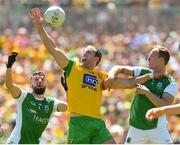 24 June 2018; Michael Murphy of Donegal is tackled by James McMahon, left, and Che Cullen of Fermanagh during the Ulster GAA Football Senior Championship Final match between Donegal and Fermanagh at St Tiernach's Park in Clones, Monaghan. Photo by Ramsey Cardy/Sportsfile