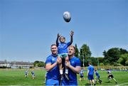 4 July 2018; Leinster players Rory O'Loughlin, left, and James Tracy with summer camp attendee, Emily Sexton, age 8, from Milltown, Co Dublin, during the Bank of Ireland Leinster Rugby Summer Camp at Energia Park in Donnybrook, Dublin. Photo by David Fitzgerald/Sportsfile