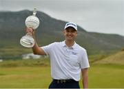 8 July 2018; Russell Knox of Scotland with the Dubai Duty Free Irish Open trophy on the 18th green after Day Four of the Dubai Duty Free Irish Open Golf Championship at Ballyliffin Golf Club in Ballyliffin, Co. Donegal. Photo by Oliver McVeigh/Sportsfile