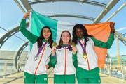 9 July 2018; Team Ireland athletes, from left, Sophie O'Sullivan, Ballymore Cobh AC, Cork, with her silver medal she won in the Girls 800m event, Sarah Healy, Blackrock AC, Dublin, with her gold medals for winning the Girls 1500m and 3000m events, and Rhasidat Adeleke, Tallaght AC, Dublin, with her gold medal for winning the Girls 200m event, during the Team Ireland homecoming from the European Athletics Under-18 Championships in Gyor, Hungary, at Dublin Airport in Dublin. Photo by Piaras Ó Mídheach/Sportsfile