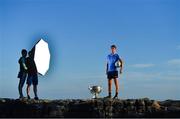 10 July 2018; Members of Aran Islands GAA club Peter Donohue and Ciarán Seoige hold the light as Michael Fitzsimons of Dublin is photographed with the Sam Maguire Cup in attendance during the GAA Hurling and Football All Ireland Senior Championship Series National Launch at Dun Aengus in the Aran Islands, Co Galway. Photo by Brendan Moran/Sportsfile