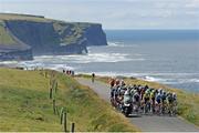 11 July 2018; A general view of the action as the peloton pass Kilkee Cliffs during the Eurocycles Eurobaby Junior Tour of Ireland 2018 Stage Two, Ennis to Kilkee in Co. Clare. Photo by Stephen McMahon/Sportsfile