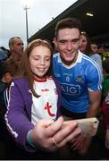21 July 2018; Brian Fenton of Dublin poses for a photograph with a young Tyrone supporter following the GAA Football All-Ireland Senior Championship Quarter-Final Group 2 Phase 2 match between Tyrone and Dublin at Healy Park in Omagh, Tyrone. Photo by Stephen McCarthy/Sportsfile