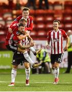 27 July 2018; Rory Patterson of Derry City, front, celebrates with teammates Dean Shiels and Ronan Hale, top, of Derry City after scoring his side's second goal in added time during the SSE Airtricity League Premier Division match between Derry City and St Patrick's Athletic at the Brandywell in Derry. Photo by Oliver McVeigh/Sportsfile