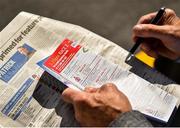 30 July 2018; A general view of a racecard as a racegoer studies the form prior to racing at the Galway Races Summer Festival 2018, in Ballybrit, Galway. Photo by Seb Daly/Sportsfile