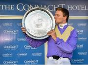 30 July 2018; Jockey Aubrey McMahon kisses the trophy after winning the Connacht Hotel (Q.R.) Handicap on Uradel during the Galway Races Summer Festival 2018, in Ballybrit, Galway. Photo by Seb Daly/Sportsfile