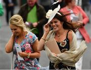 31 July 2018; Racegoers battle the wind as they arrive prior to racing at the Galway Races Summer Festival 2018, in Ballybrit, Galway. Photo by Seb Daly/Sportsfile