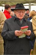 1 August 2018; President Michael D Higgins studies the form prior to the TheTote.com Galway Plate Steeplechase Handicap during the Galway Races Summer Festival 2018, in Ballybrit, Galway. Photo by Seb Daly/Sportsfile