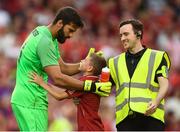 4 August 2018; Alisson Becker of Liverpool with a young supporter who received his gloves following the Pre Season Friendly match between Liverpool and Napoli at the Aviva Stadium in Dublin. Photo by Stephen McCarthy/Sportsfile