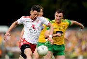 5 August 2018; Mattie Donnelly of Tyrone in action against Leo McLoone of Donegal during the GAA Football All-Ireland Senior Championship Quarter-Final Group 2 Phase 3 match between Tyrone and Donegal at MacCumhaill Park in Ballybofey, Co Donegal.Photo by Philip Fitzpatrick/Sportsfile