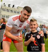 5 August 2018; Richard Donnelly of Tyrone and 9 year old Niall McCann from Trillick, Tyrone, celebrate after the GAA Football All-Ireland Senior Championship Quarter-Final Group 2 Phase 3 match between Tyrone and Donegal at MacCumhaill Park in Ballybofey, Co Donegal. Photo by Oliver McVeigh/Sportsfile
