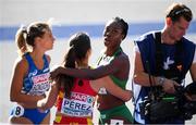 6 August 2018; Gina Akpe-Moses of Ireland, second from right, embraces Maria Izabel Pérez of Spain after competing in the Women's 100m Heats during Day Q of the 2018 European Athletics Championships at Berlin in Germany.  Photo by Sam Barnes/Sportsfile