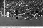 18 September 1983. Dublin's Brian Mullins is sent off by Referee Sean McKeogh as a Galway players lies on the ground. All-Ireland Football Final, Dublin v Galway, Croke Park. Photo by Ray McManus/Sportsfile