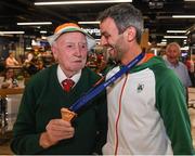 13 August 2018; Thomas Barr shows his medal to Irish athletics supporter Harry Gorman at the Homecoming of the Irish Team from the European Athletics Championships in Berlin at Terminal 1 in Dublin Airport. Photo by Eóin Noonan/Sportsfile
