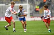 12 August 2018; Lorcan Buckley, Ballapousta NS, Ardee, Co Louth, representing Monaghan, in action against Sean MacConmara, Gaelscoil Aonach Urmhumhan, Co Tipperary, representing Tyrone, left, and Michael Kavanagh, Castletown NS, Gorey, Co Wexford, representing Tyrone, during the INTO Cumann na mBunscol GAA Respect Exhibition Go Games at the GAA Football All-Ireland Senior Championship Semi Final match between Monaghan and Tyrone at Croke Park in Dublin.  Photo by Piaras Ó Mídheach/Sportsfile