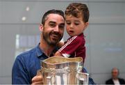 17 August 2018; Darragh Madden, from Oranmore, Co Galway, with his son Conor, age 2, with the Liam MacCarthy Cup at the GAA Fáilte Abhaile event at Dublin Airport in Dublin. Photo by Piaras Ó Mídheach/Sportsfile