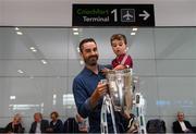 17 August 2018; Darragh Madden, from Oranmore, Co Galway, with his son Conor, age 2, with the Liam MacCarthy Cup at the GAA Fáilte Abhaile event at Dublin Airport in Dublin. Photo by Piaras Ó Mídheach/Sportsfile