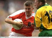 31 August 2003; Philip Loughran, Armagh, in action against Donegal's Brian Roper during the Bank of Ireland All-Ireland Senior Football Championship Semi-Final between Armagh and Donegal at Croke Park in Dublin. Photo by Ray McManus/Sportsfile