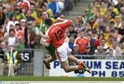 29 August 2003; Oisin McConville, Armagh, is tackled by  Donegal's Raymond Sweeney who was issued with a second 'Yellow Card' and sent off during the Bank of Ireland All-Ireland Senior Football Championship Semi-Final between Armagh and Donegal at Croke Park in Dublin. Photo by Ray McManus/Sportsfile