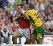 29 August 2003; Enda McNulty, Armagh, prepares to clear under pressure from Donegal's Adrian Sweeney during the Bank of Ireland All-Ireland Senior Football Championship Semi-Final between Armagh and Donegal at Croke Park in Dublin. Photo by Ray McManus/Sportsfile
